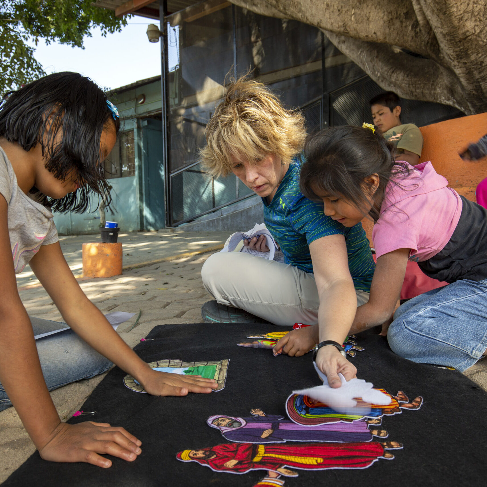 An IMB missionary uses a flannelgraph characters to tell a Bible story to residents of the Casa Hogar Children's Home in Oaxaca, Mexico. Rather than trying to tell stories to a large group, the missionary prefers to give more personalized attention to two or three children at a time.
