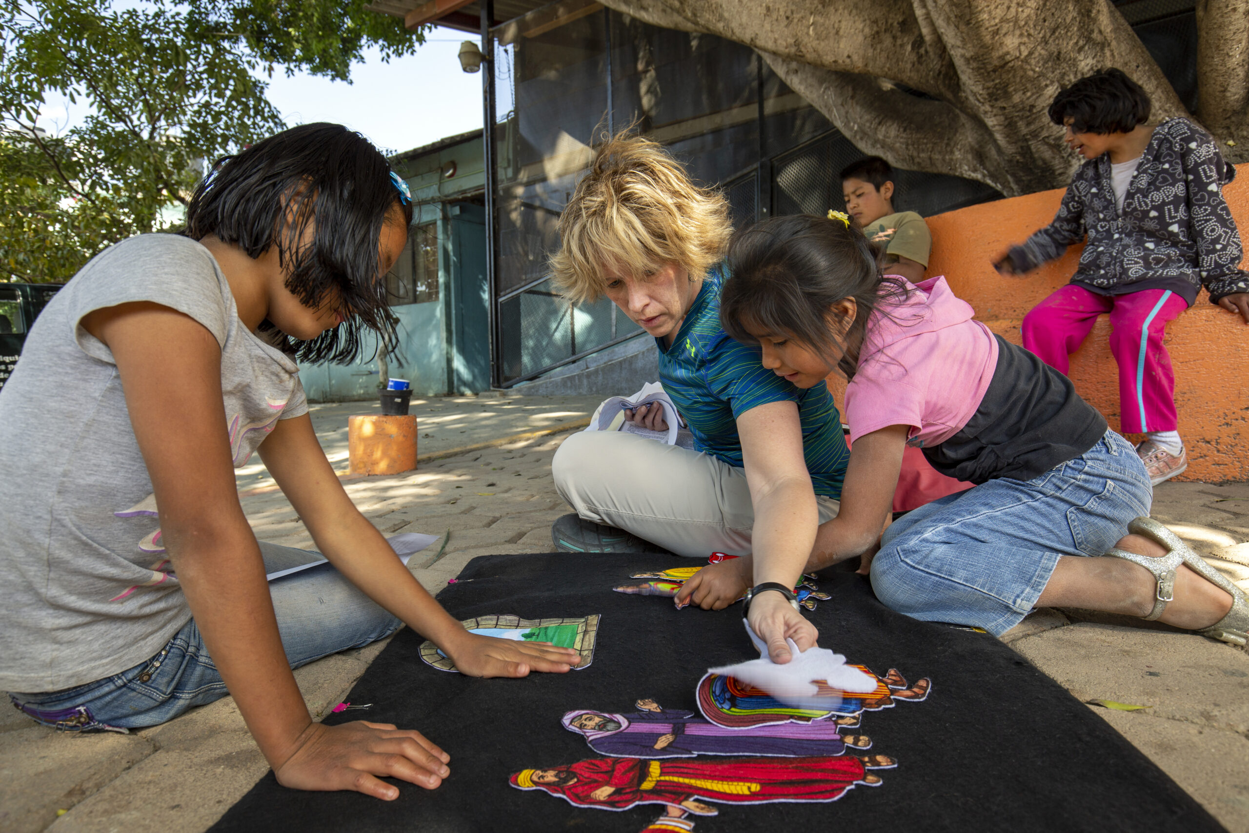 An IMB missionary uses a flannelgraph characters to tell a Bible story to residents of the Casa Hogar Children's Home in Oaxaca, Mexico. Rather than trying to tell stories to a large group, the missionary prefers to give more personalized attention to two or three children at a time.